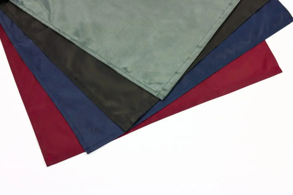 a Group of Four Different Coloured Bib Aprons Sitting on Top of Each Other