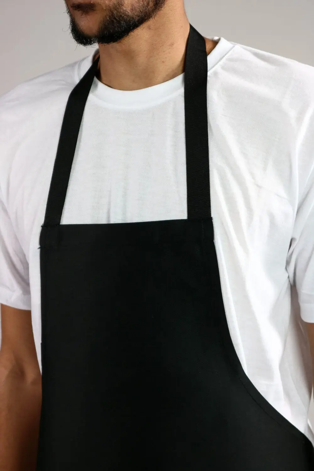 Closeup of a Man Wearing a Basic Black Bib Apron